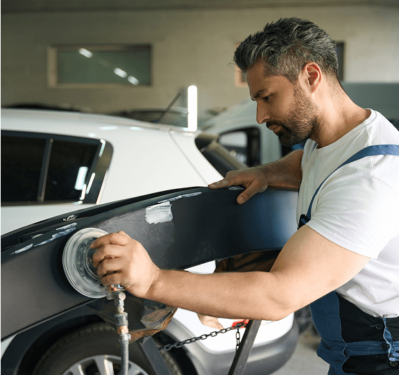 Mechanic repairing a car bumper